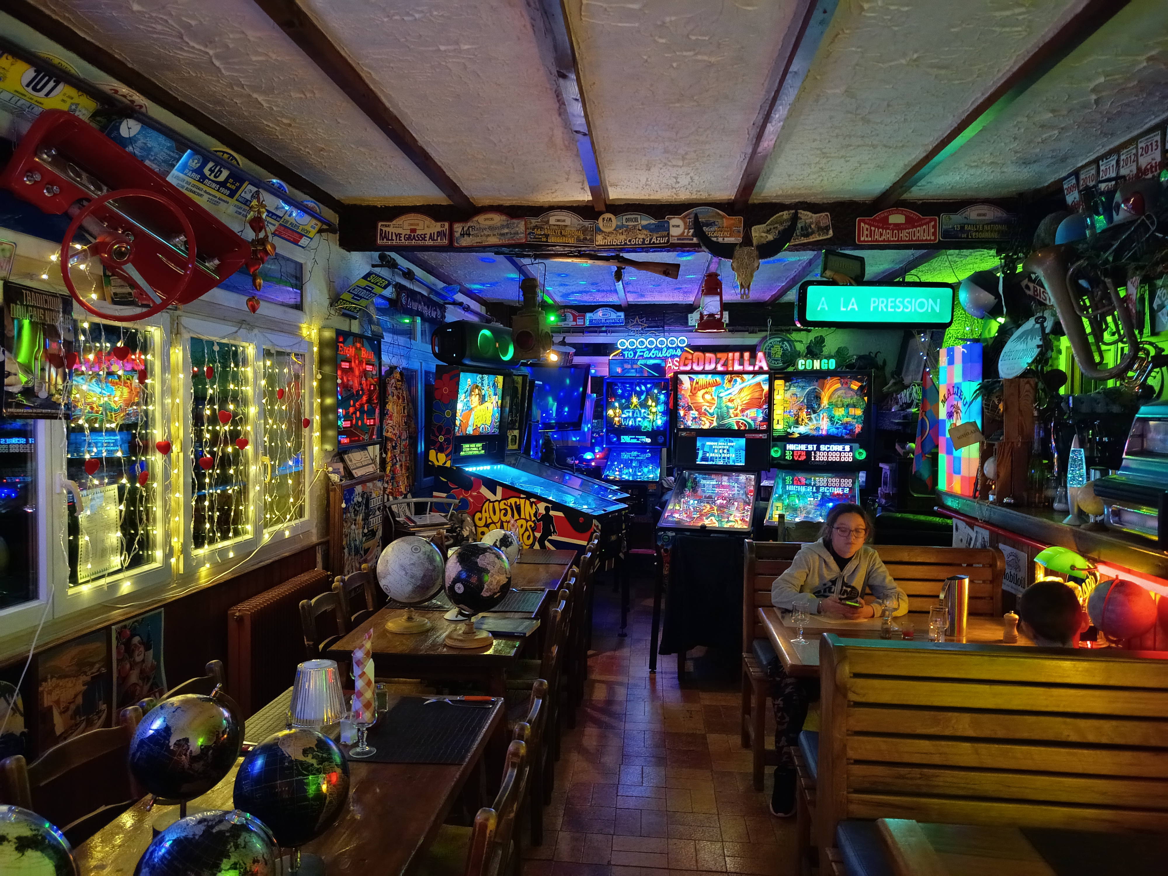 Salle du restaurant Les Chamois - flippers, n&eacute;ons bleus et guirlandes
